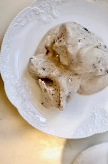 a scoop of ice cream in a white bowl