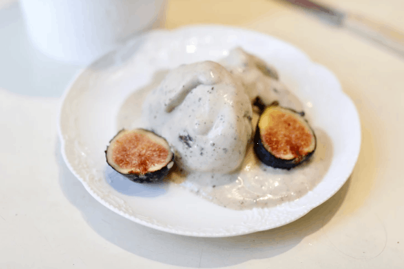 plate with ice cream scooped and 2 figs on it