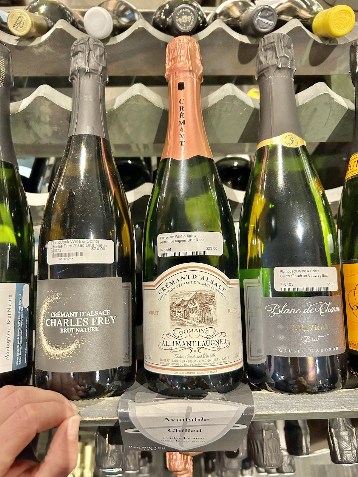 bottles of champagne lined up on a shelf