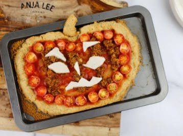 a pizza in a shape of a jack o lantern