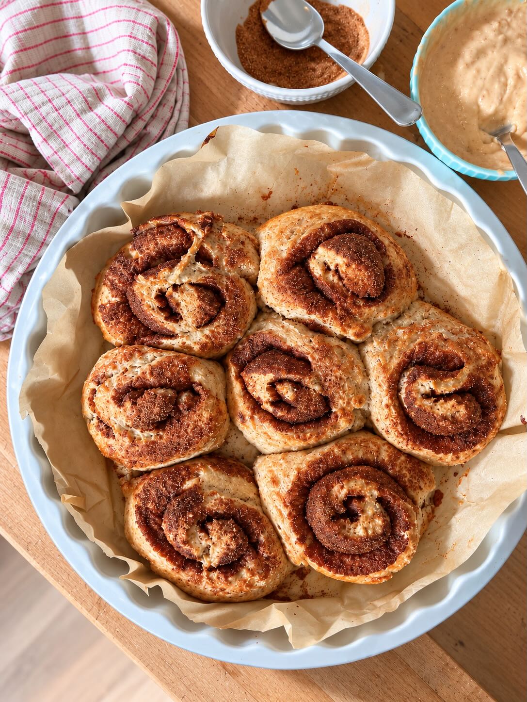 Golden baked cinnamon rolls in a baking dish