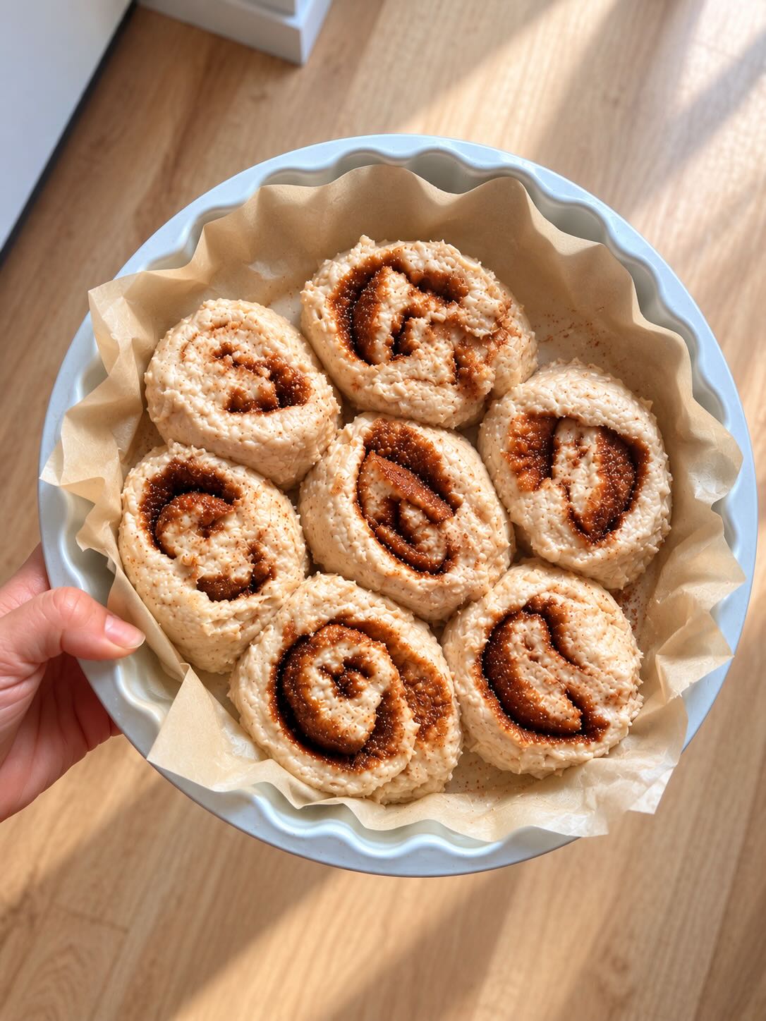 Unbaked cinnamon rolls nestled in a baking dish